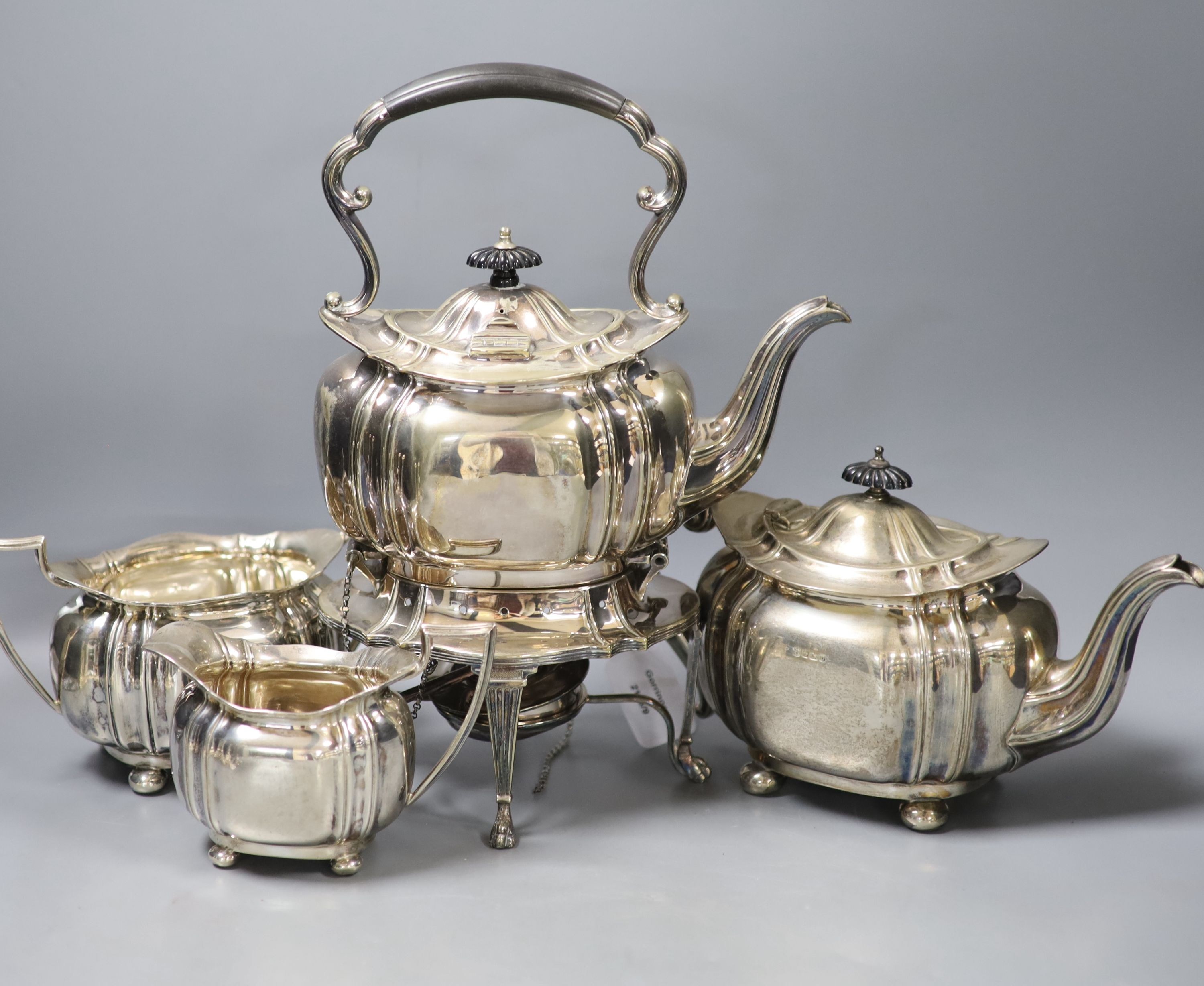 A George V silver three piece tea set, Cooper Brothers & Sons, Sheffield, 1913, gross 42oz, together with a similar plated tea kettle on stand with burner.